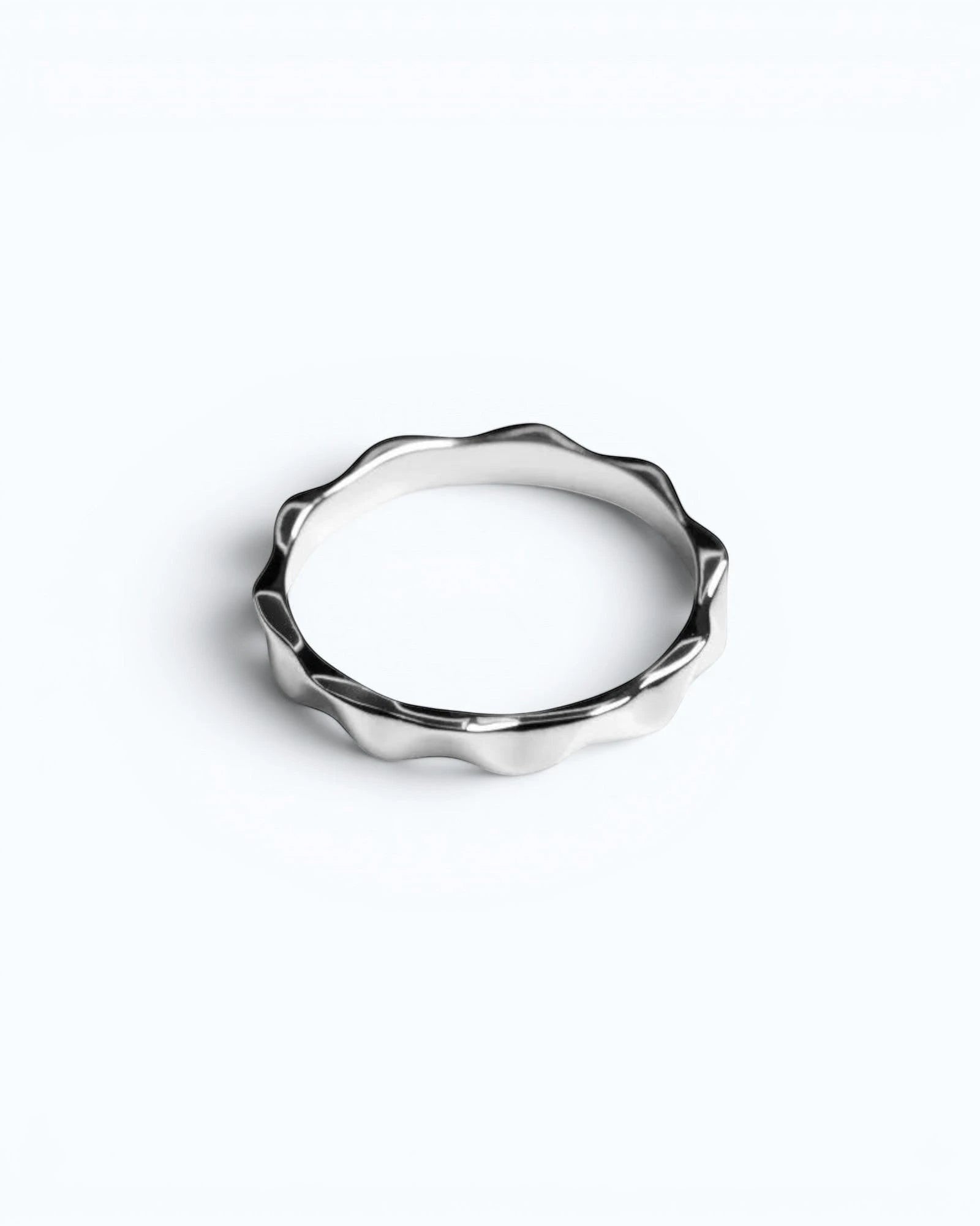 Pearlystones silver metal wavy band ring with geometric facets, perfect for stacking.