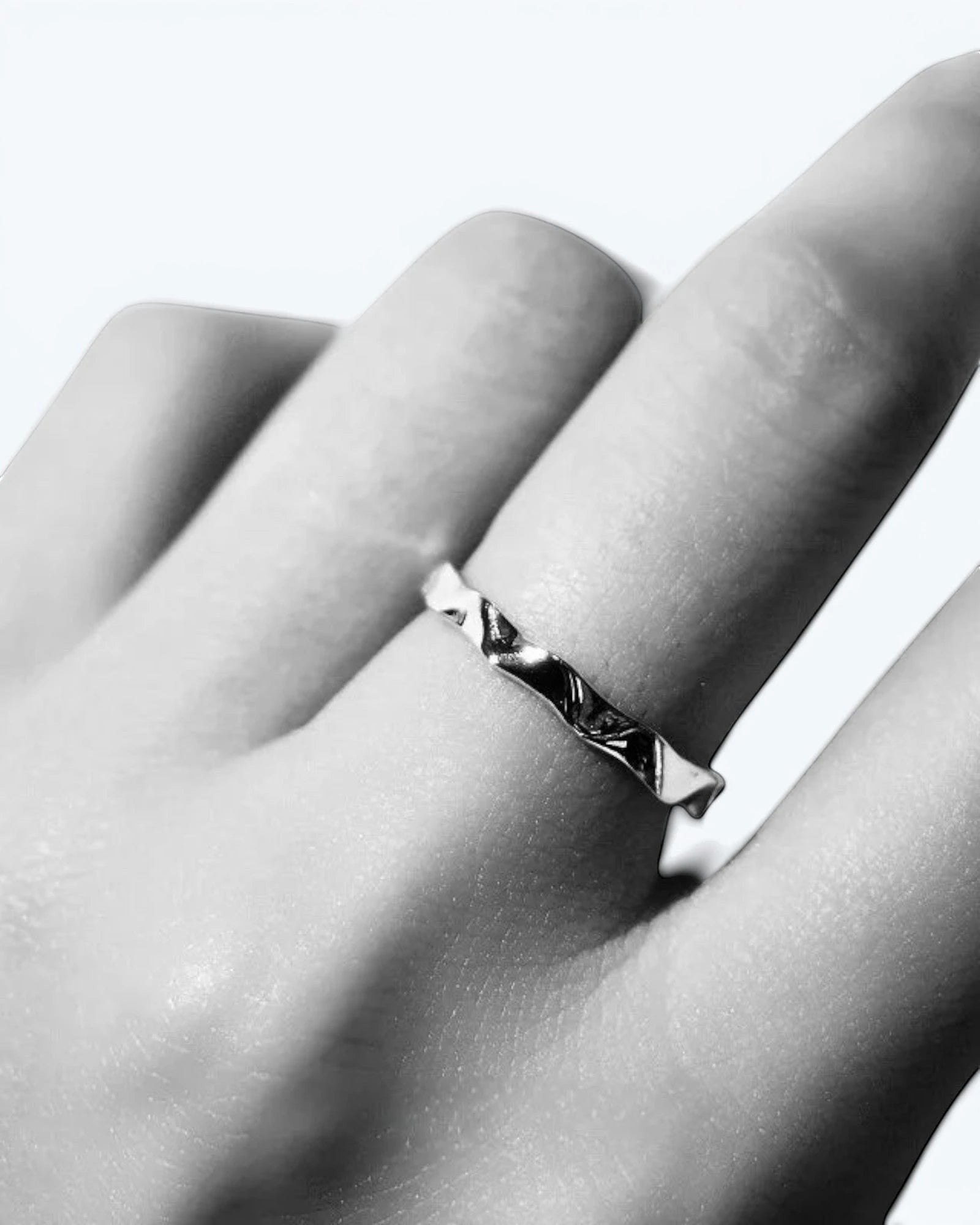 Pearlystones silver wavy band ring with geometric facets, perfect for stacking.