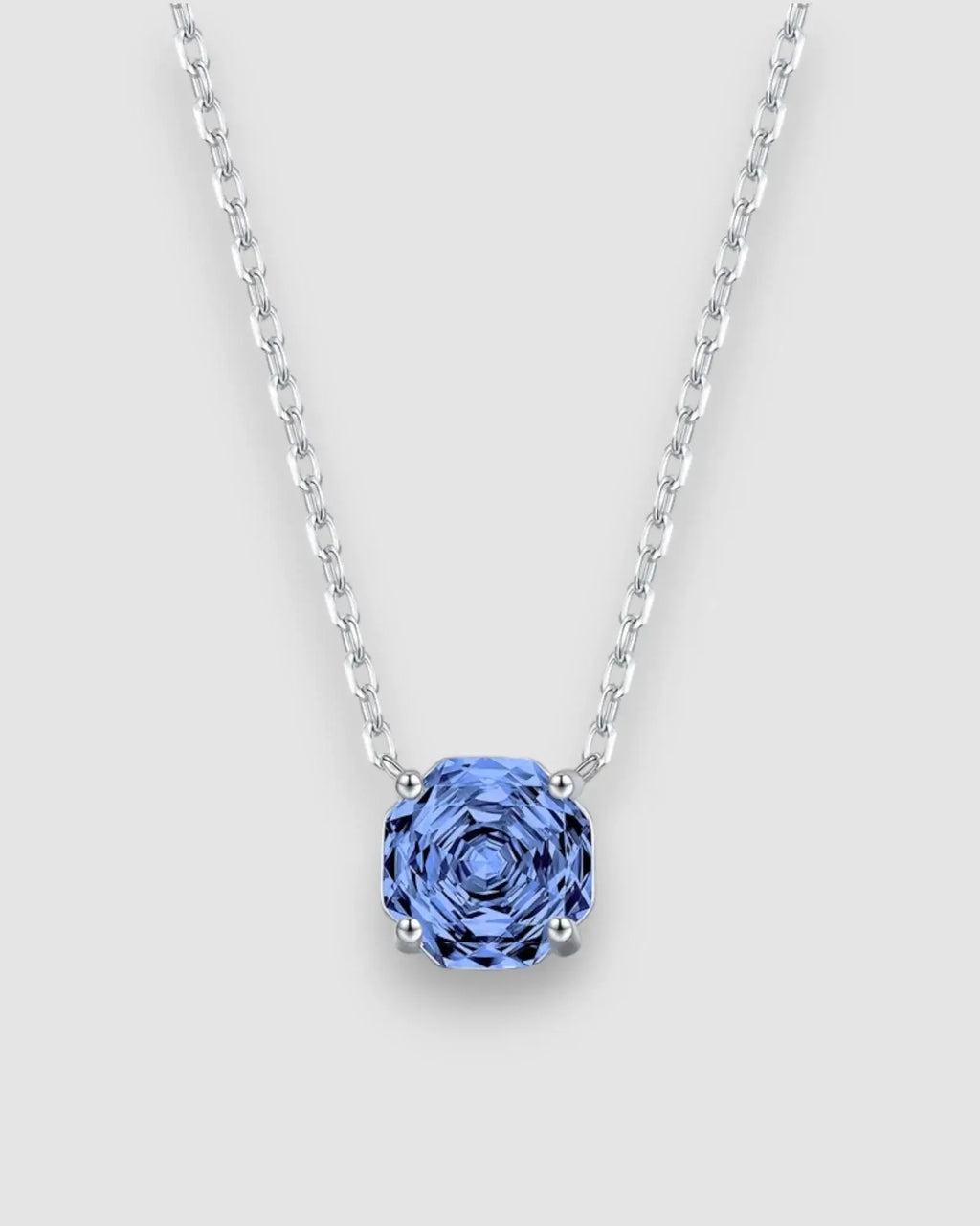 Octagonal Rose Cut Tanzanite Blue Zircon Pendant Necklace in Silver with a sparkling blue stone on a silver chain.