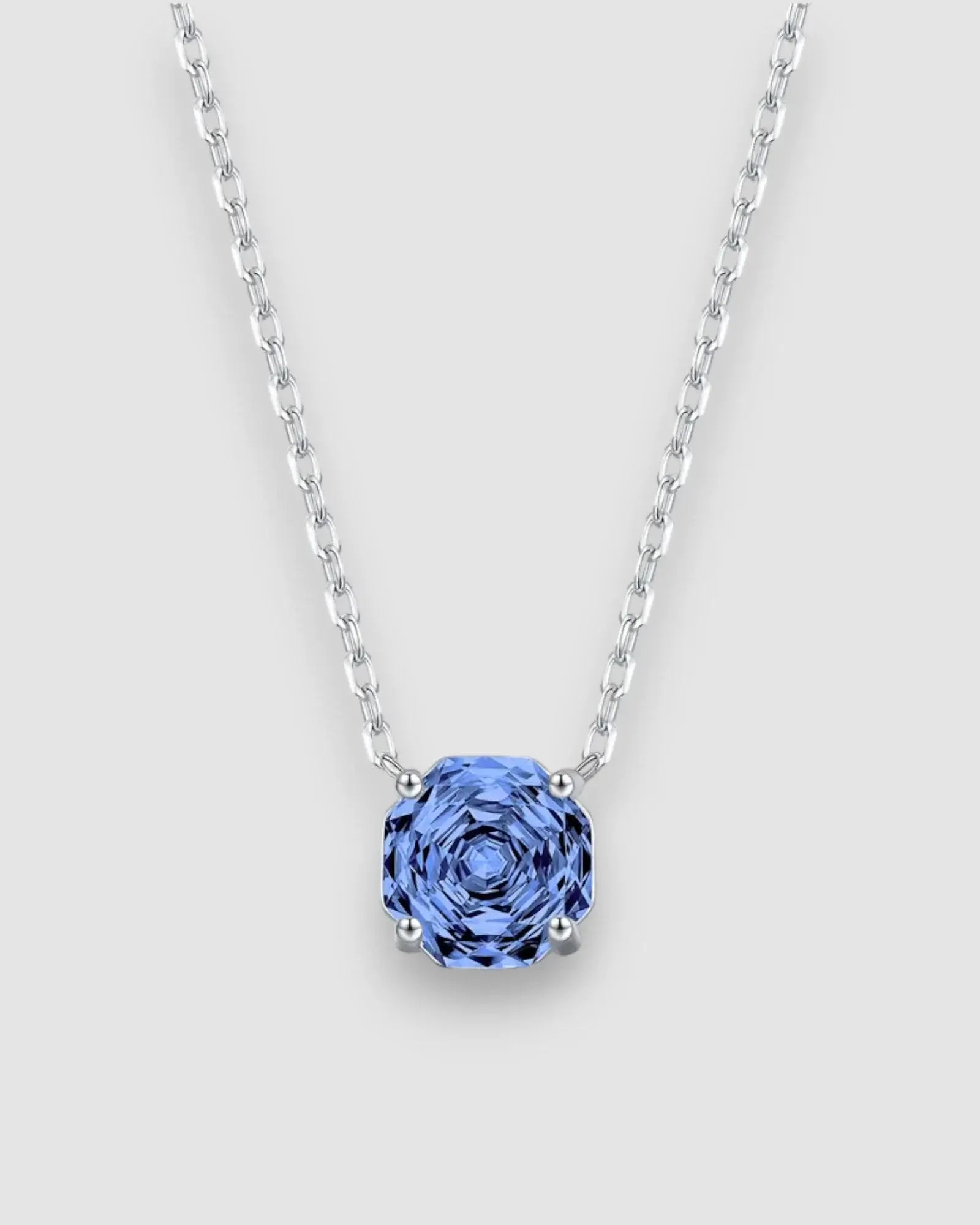 Octagonal Rose Cut Tanzanite Blue Zircon Pendant Necklace in Silver with a sparkling blue stone on a silver chain.