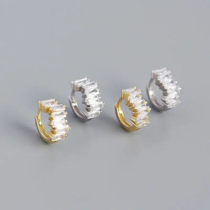 Sparkly sterling silver hoops with white gold and gold plating, adding a touch of elegance to any outfit.