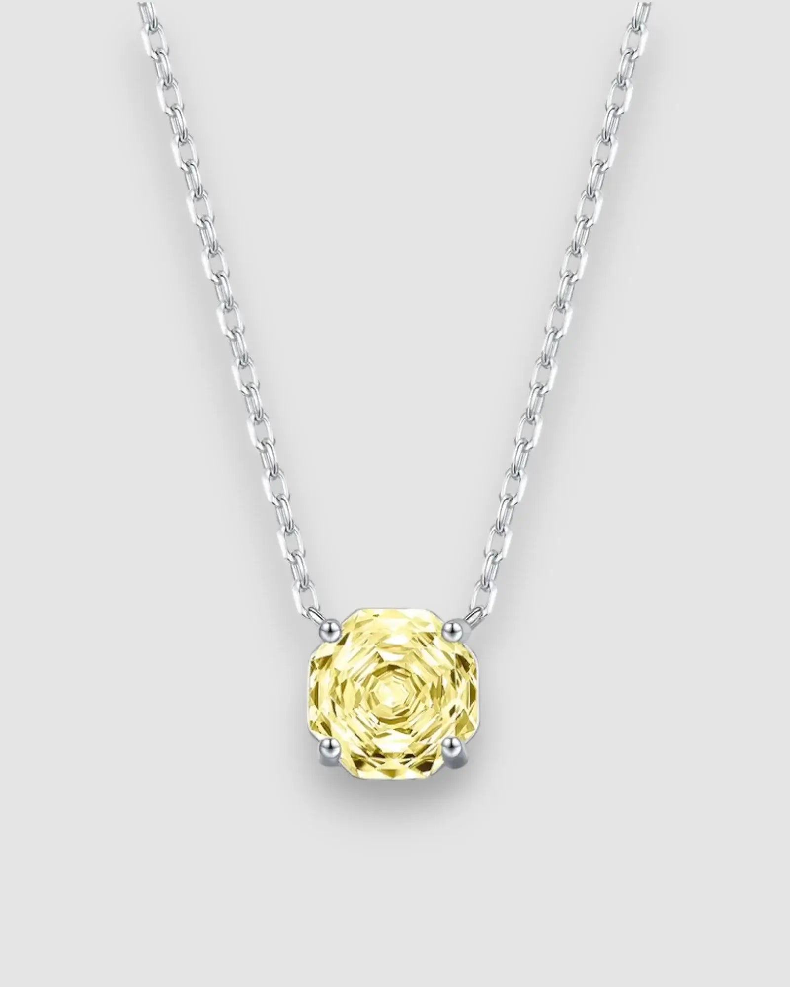Yellow zircon pendant necklace featuring an octagonal rose cut stone set in sterling silver chain.