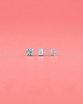 5mm Round brilliant cut moissanite studs with sterling silver and rhodium finish on a pink background.