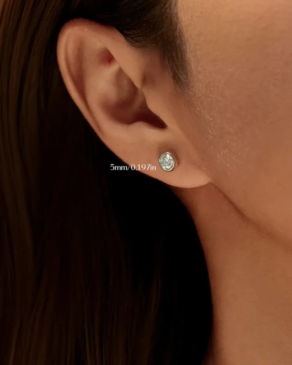 1Ct Round Bubble moissanite studs showcased in a model's ear, featuring a 5mm sparkling design.