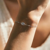 0.5 ct moissanite halo bracelet on a woman's wrist showcasing elegant sparkle and simple design.