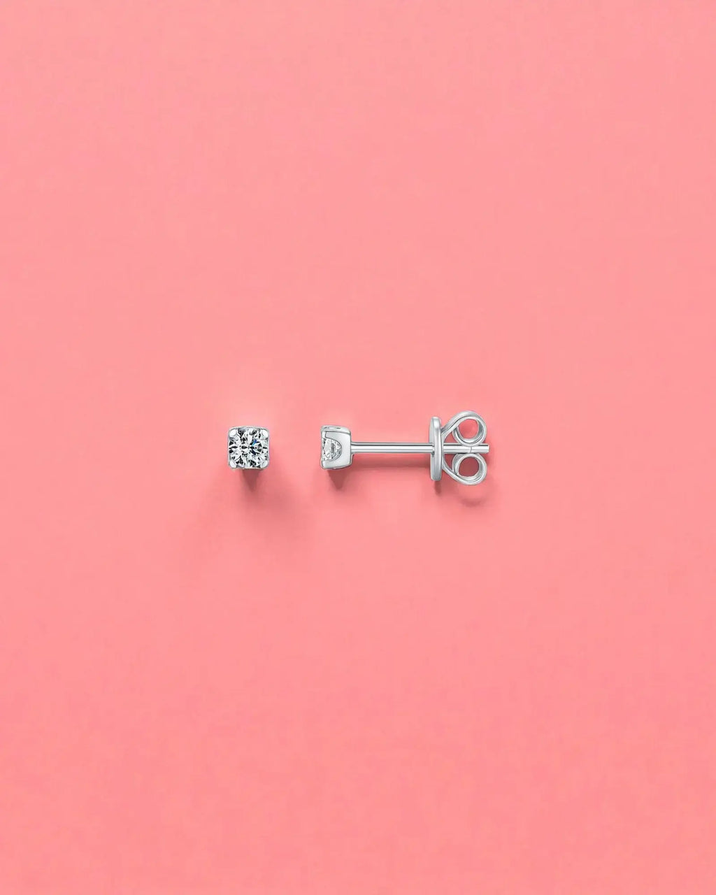 3mm Round brilliant cut moissanite studs on a pink background, showcasing their sterling silver and rhodium finish.