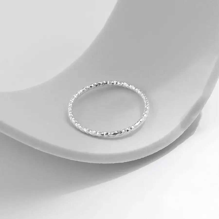 Silver Wave Textured Ring on a soft background showcasing its metallic shine and unique wave design.