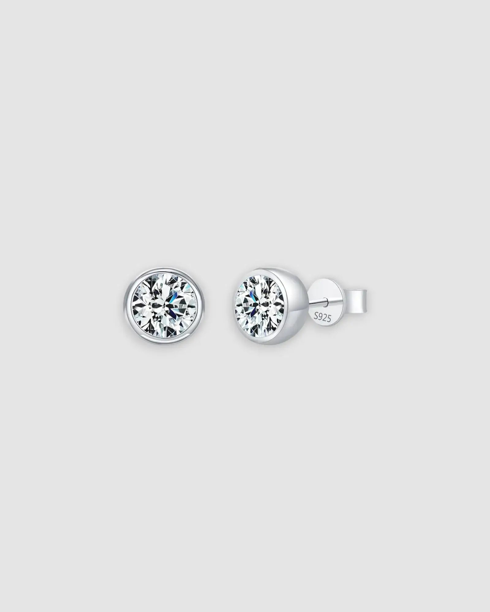 2Ct Round Bubble Moissanite studs in sterling silver with a rhodium finish, featuring a modern bezel setting.