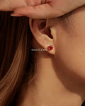 Octagonal Rose Cut Deep Red Zircon Stud in Silver worn on ear, showcasing 6mm size and elegant design.