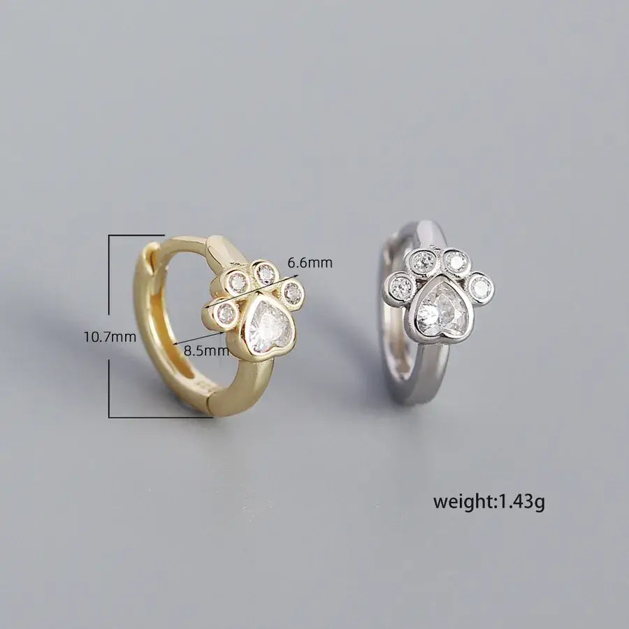 Sterling silver cat paw design hoops in gold and silver, showcasing delicate craftsmanship and elegant style.