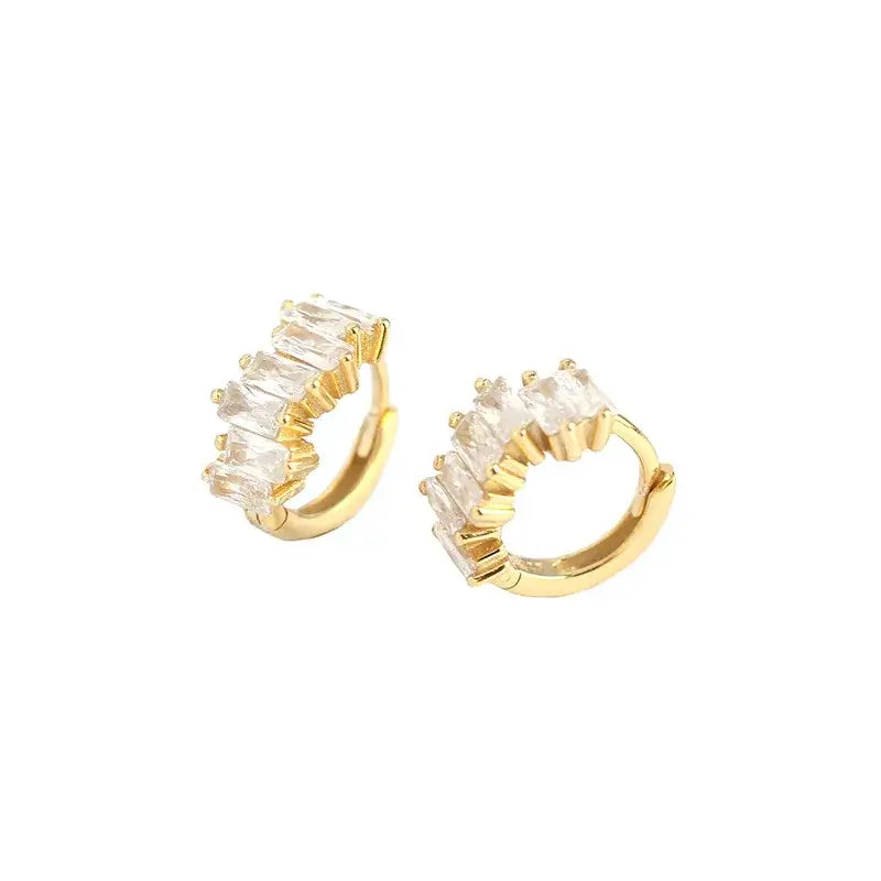 Elegant gold hoop earrings adorned with sparkling clear stones, perfect for adding a touch of glamour to any outfit.