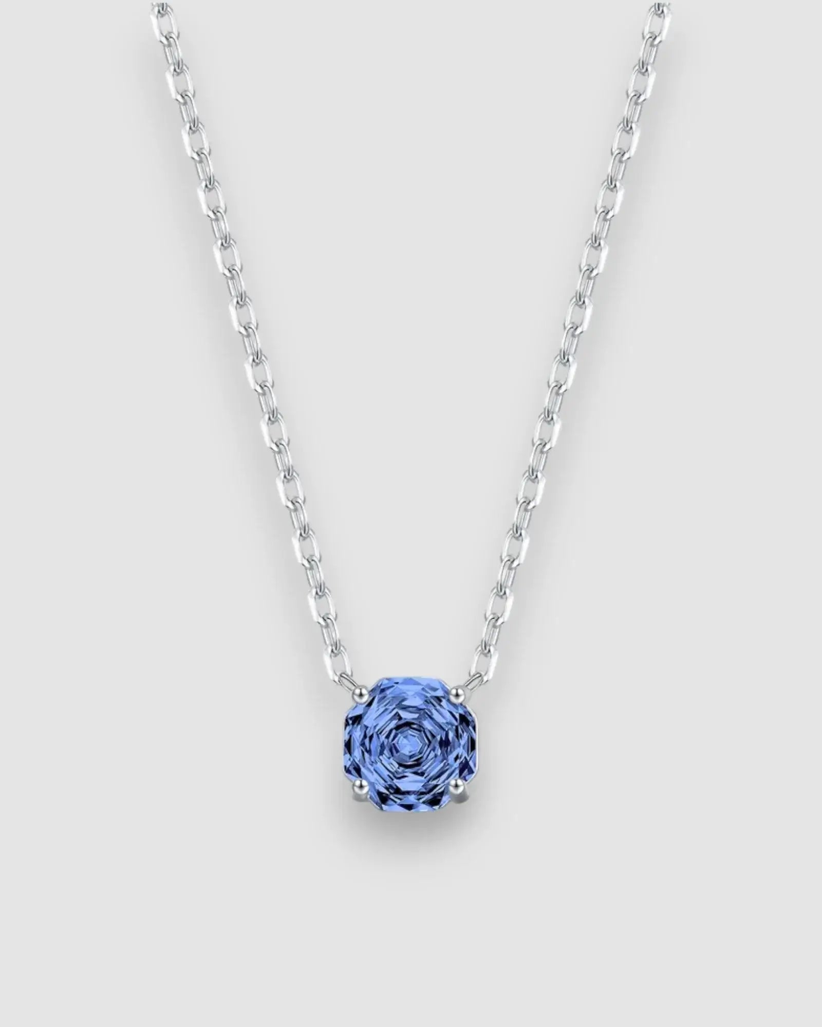 Octagonal Rose Cut Tanzanite Blue Zircon Pendant Necklace in Silver showcasing a blue stone on a silver chain.