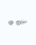 Heart-shaped silver earrings with clear gemstones on a light gray background
