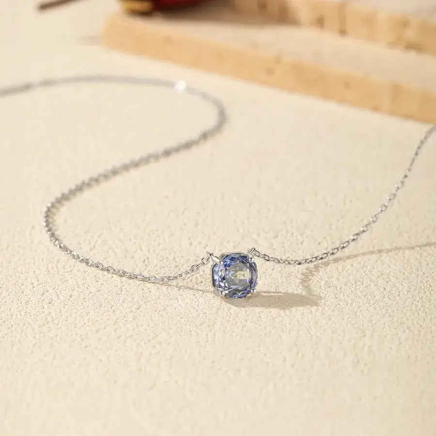 Octagonal Rose Cut Tanzanite Blue Zircon Pendant Necklace in Silver on a light background.