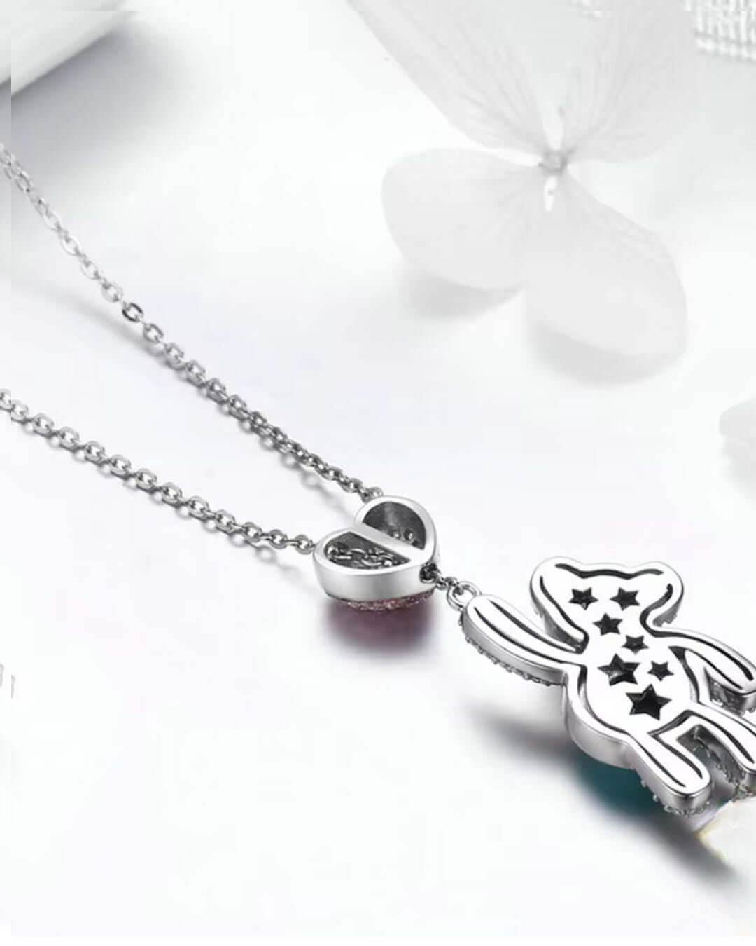 Elegant 925 Sterling Silver teddy bear pendant necklace with a heart charm and star designs.