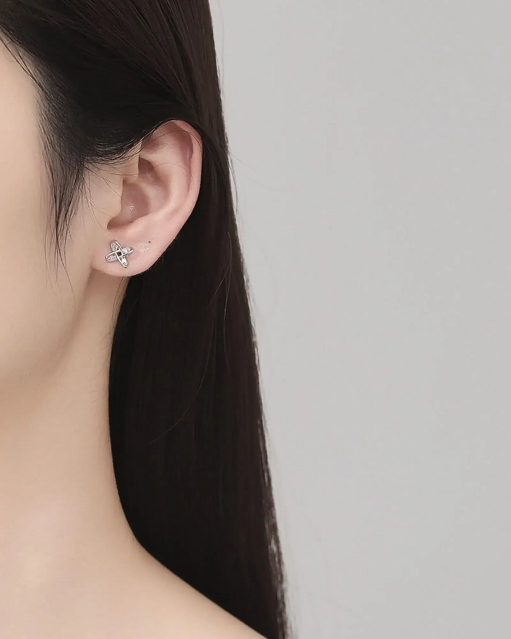 Close-up of a model wearing Windmill Ear Studs made from 925 sterling silver, showcasing elegant design.