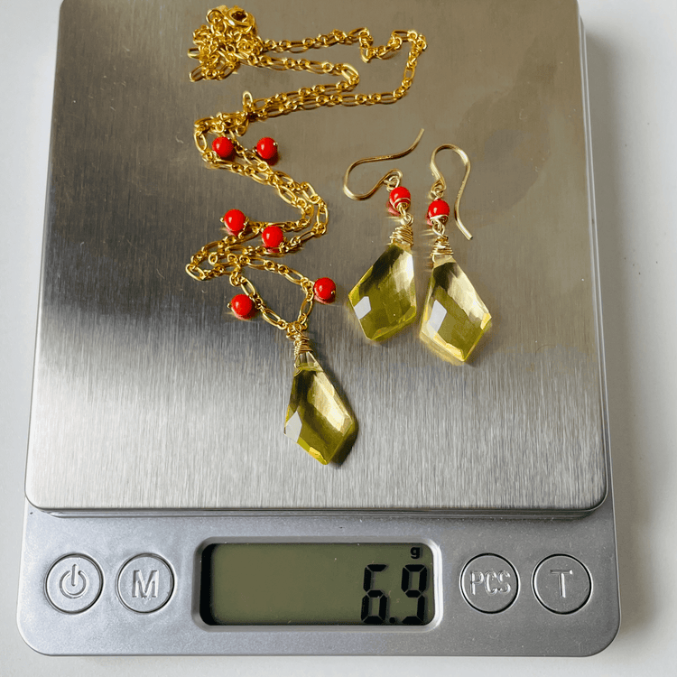 a scale with a pair of earrings on it