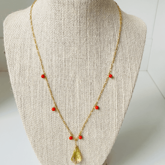 a necklace on a mannequin on a white background