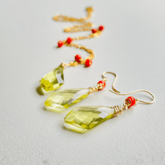 a pair of earrings with yellow and red beads