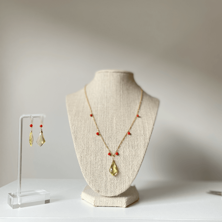 a necklace and earring set on display