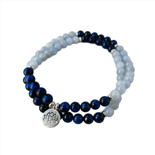 Aquamarine and Blue Tiger&#39;s Eye Long Necklace with Lotus Charm in Silver Plate. A harmonious blend of calming aquamarine and bold blue tiger&#39;s eye beads, adorned with an elegant lotus charm in silver-plated brilliance.&quot;