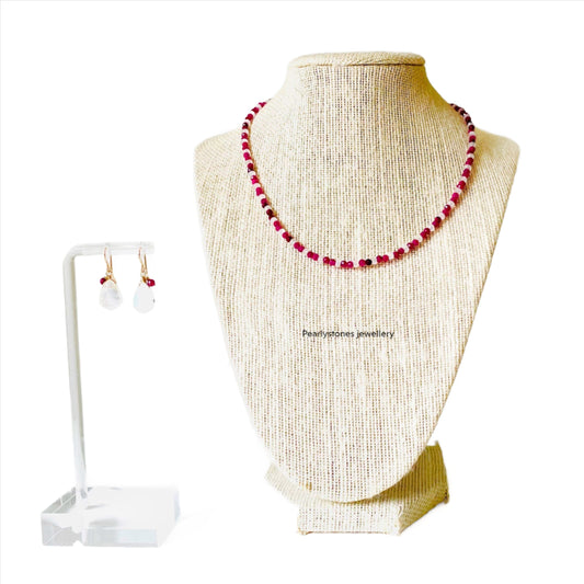a necklace and earring set on a mannequin