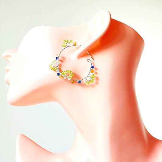 a mannequin head with a pair of earrings on it
