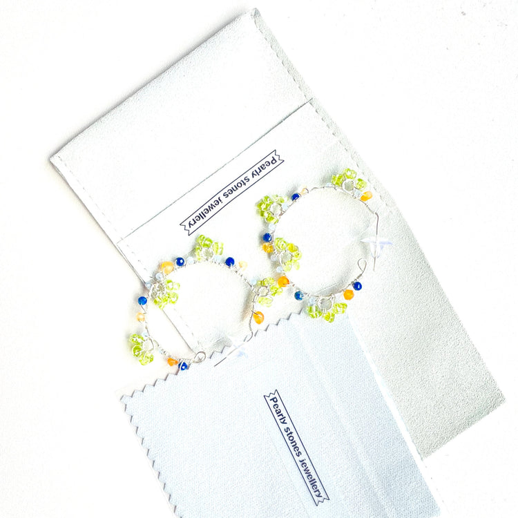 a pair of colorful beaded earrings sitting on top of a piece of paper