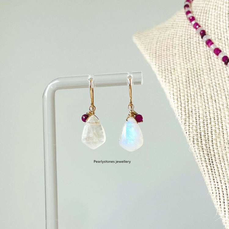 a pair of earrings sitting on top of a table